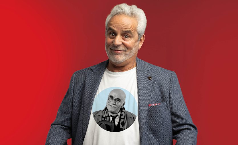 Daniel Mitchell wearing white tshirt with image of Warren Mitchell.