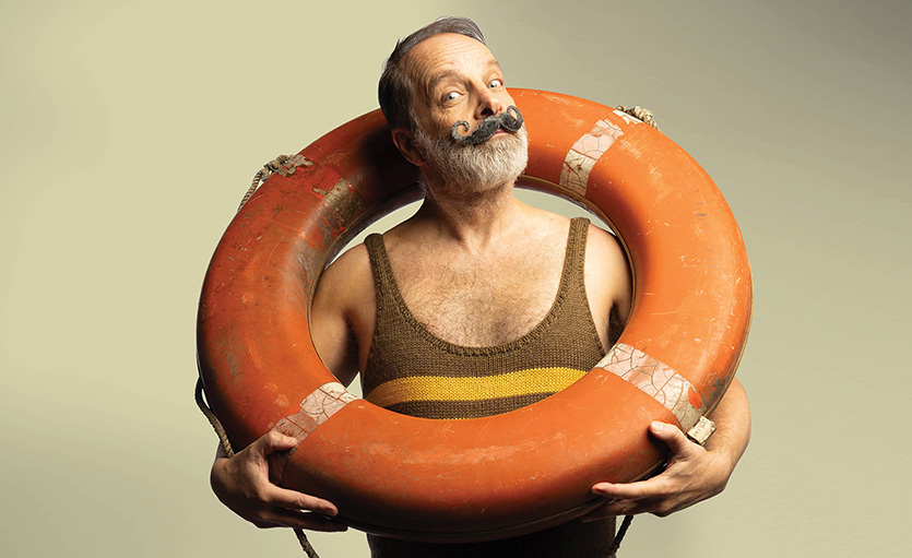 Man holding life ring with 1920s handlebar moustache
