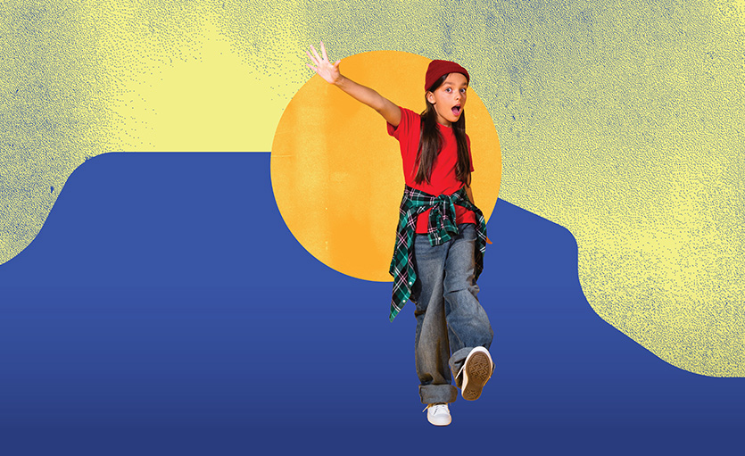 girl in jeans and red tshirt kicking her leg, looking happy, bright sun and colours in background.